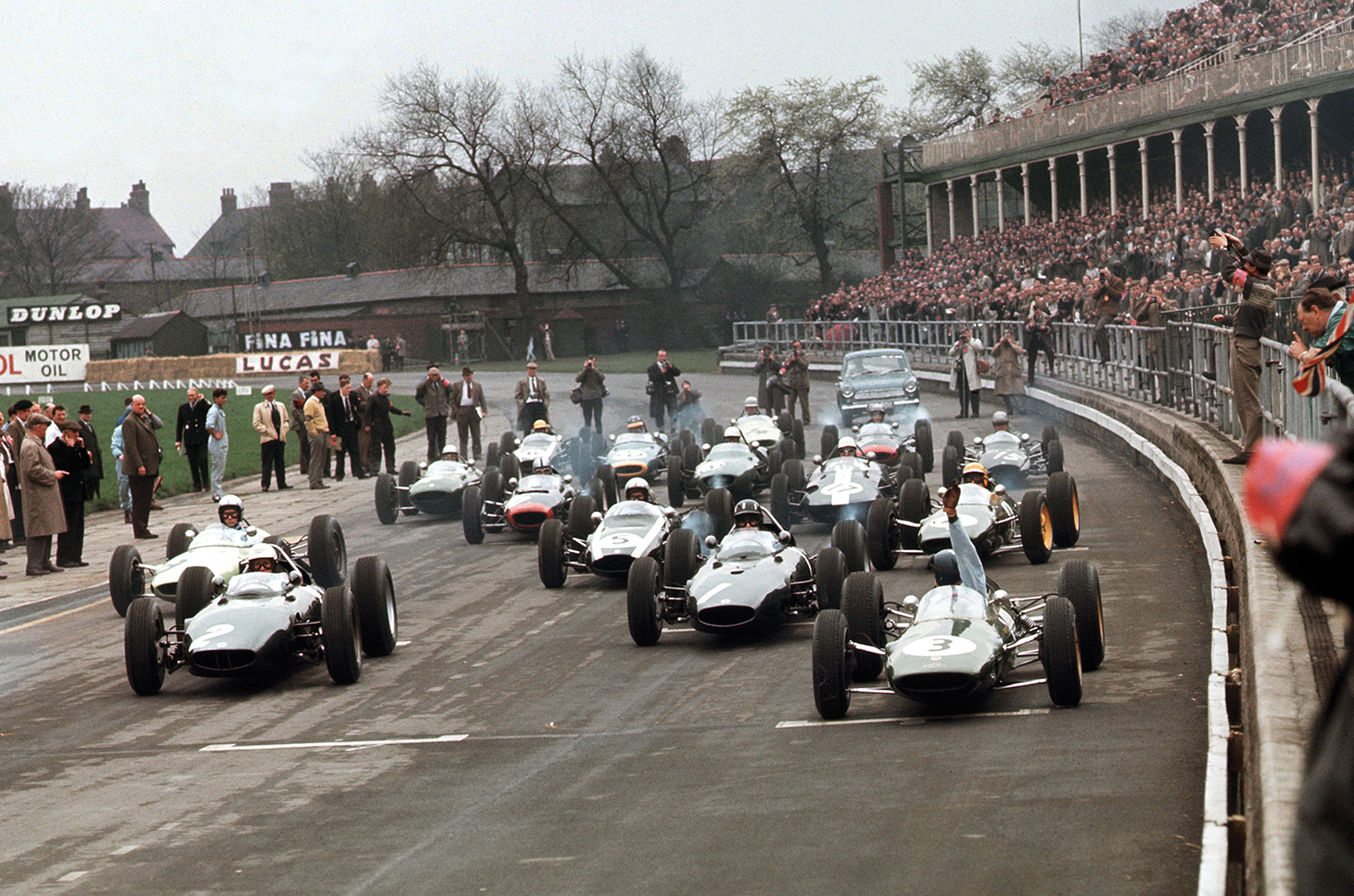 At Aintree on 27 April 1963, Jim Clark raises his hand as his Lotus 25-Climax fails to fire at the start